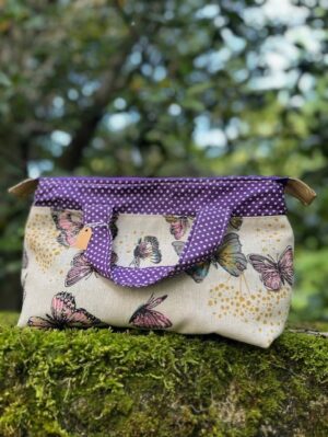 Trousse zippée à anses papillons mauves